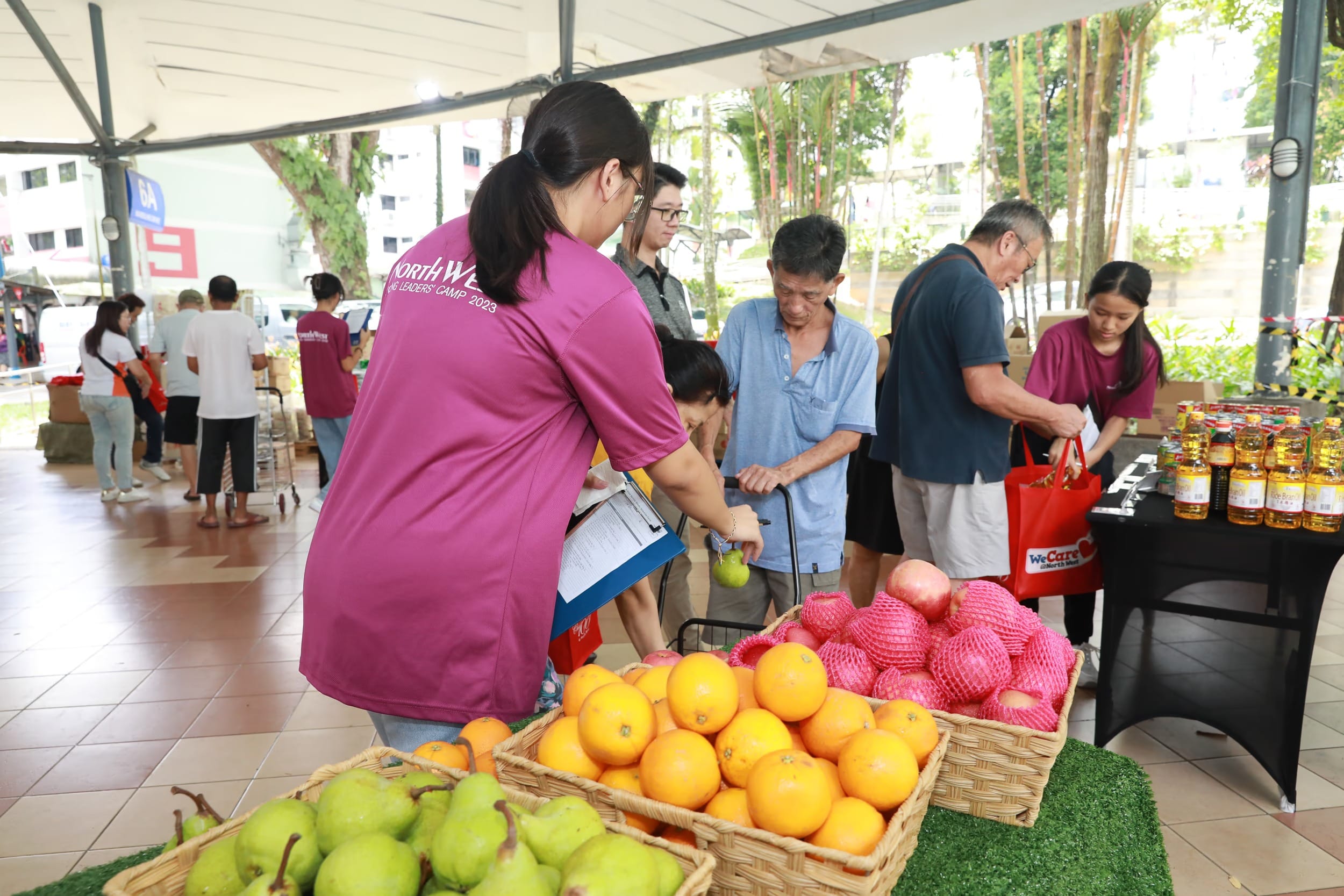 volunteer helping beneficiary at the north west service weeks pop-up market